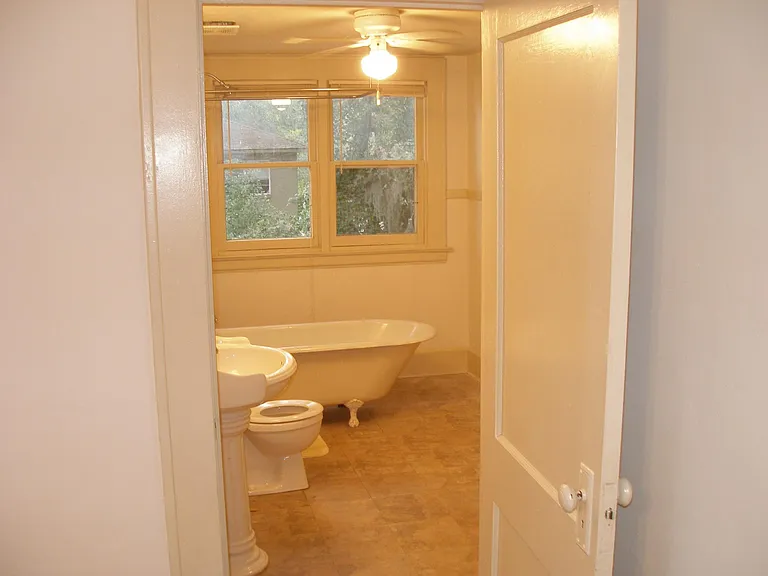 Picture of bathroom with clawfoot tub. Linen closet