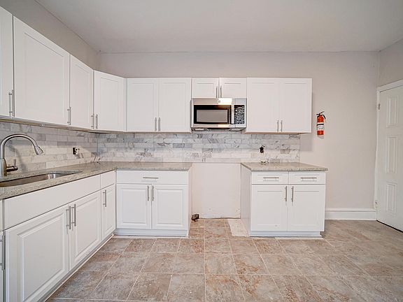 Kitchen includes a stove and fridge