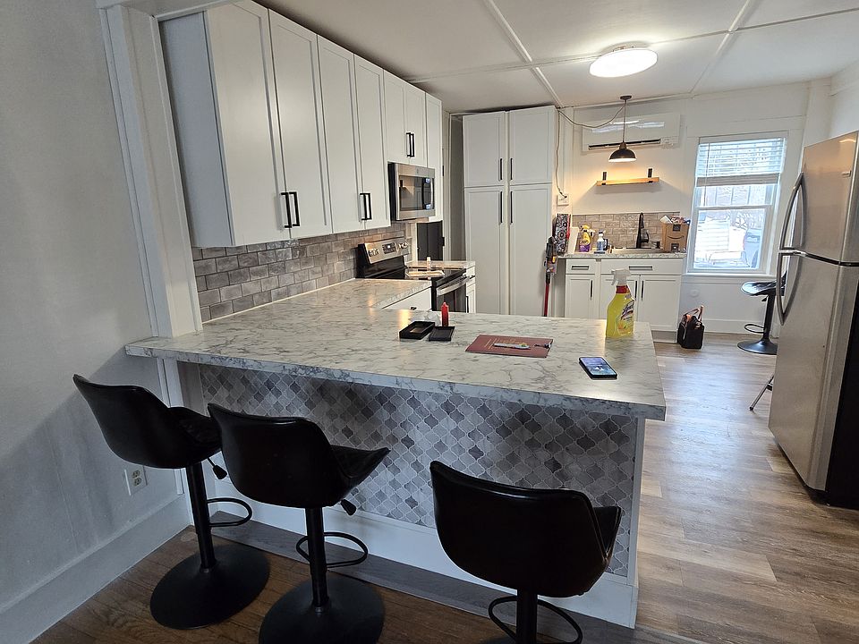 Open kitchen to living room with barstools.