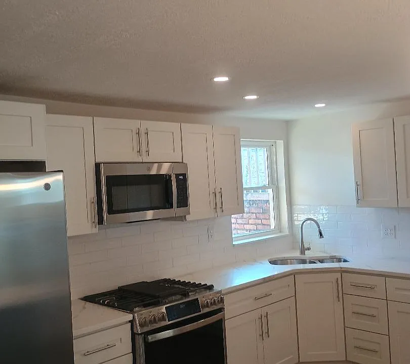 Kitchen area with stainless steel appliances and granite countertops/island