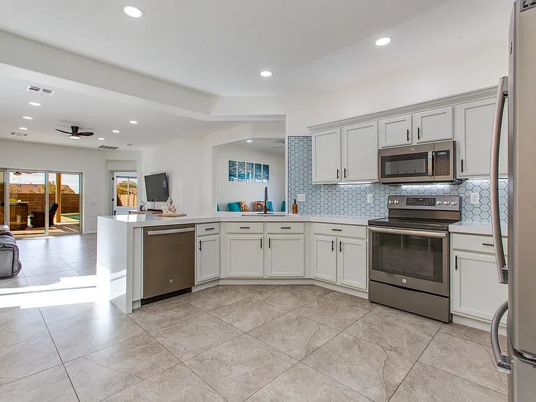 Tiled Backsplash, Waterfall Counter Top, Electric Stove Top, Motion Under and over Cabinet Lighting