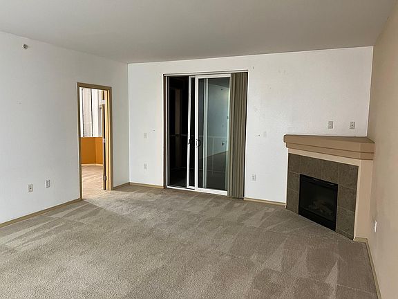 Doorway to primary bedroom. Sliding doors to balcony.