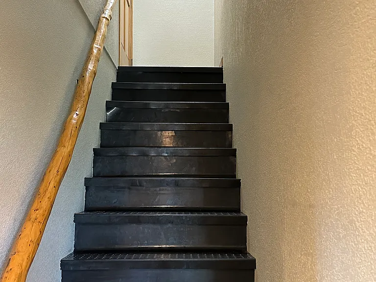 Coat rack at the top of the stairs.