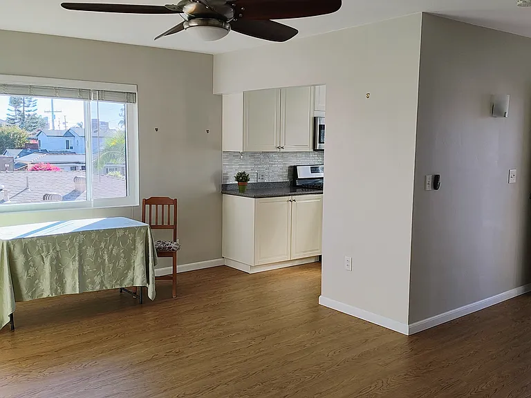 Living area to dining, kitchen and entrance on right