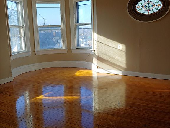 Living room hardwood floors stained glass window