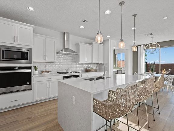 Stylish modern kitchen with stainless-steel appliances and accent lighting.