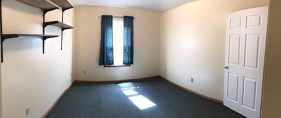 South West Bedroom with shelving and closet