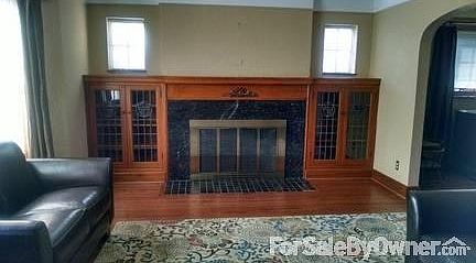 Living room
						:
						Fireplace with leaded glass built-ins and detailed woodwork