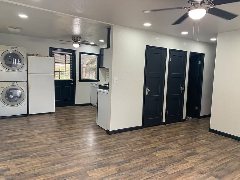 View from living room towards bathroom and bedrooms, and kitchen