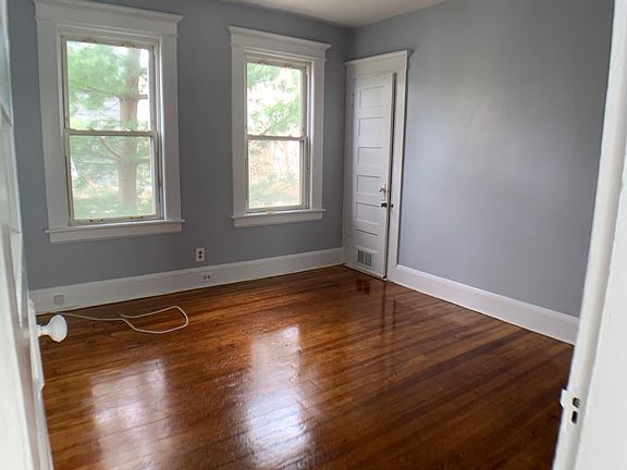 Bedroom #1 with two windows that let in natural light and a large walk in closet