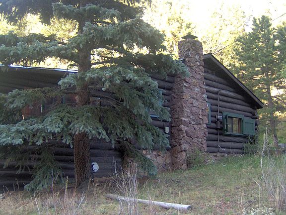 1929 log cabin with native stone fireplace