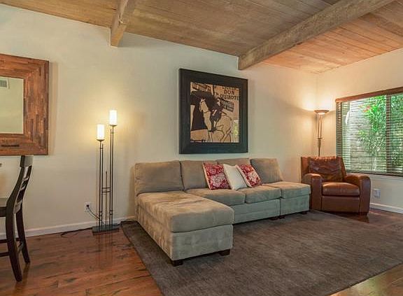 living room with wooden beam ceilings