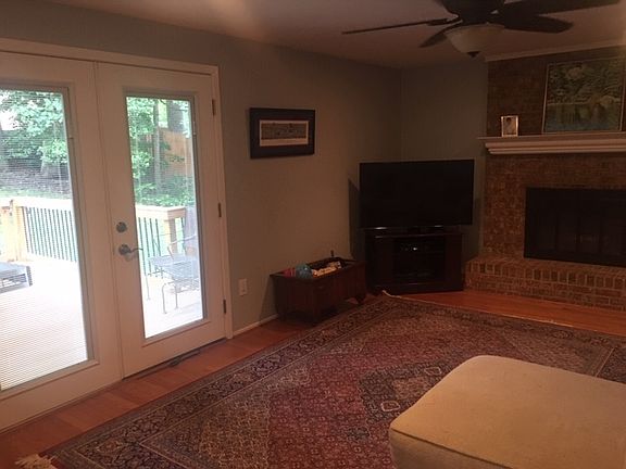 Den to deck w/wood fireplace