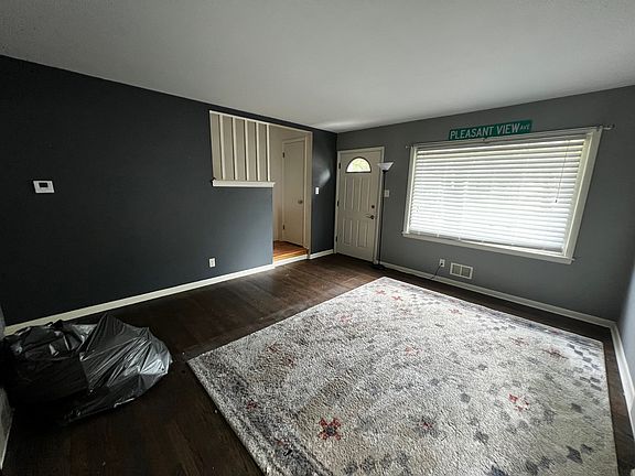 Bright living room with a large picture window overlooking the front yard