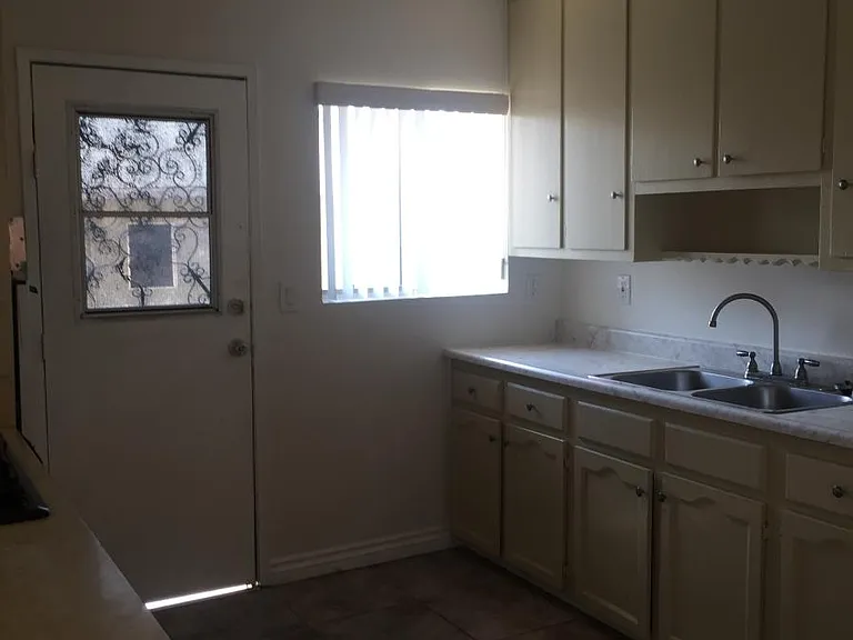 Kitchen has door that walks out to balcony