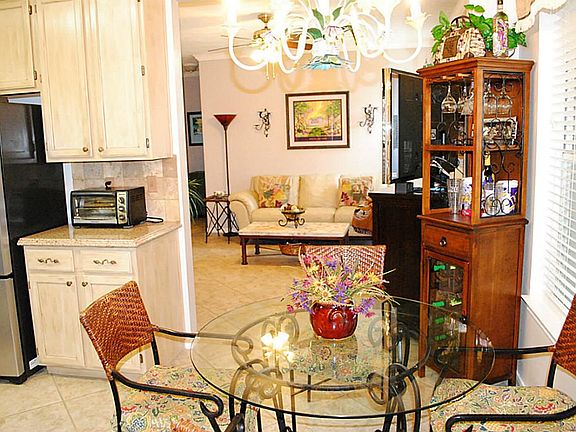 A view of the breakfast area with large window looking onto the covered patio.