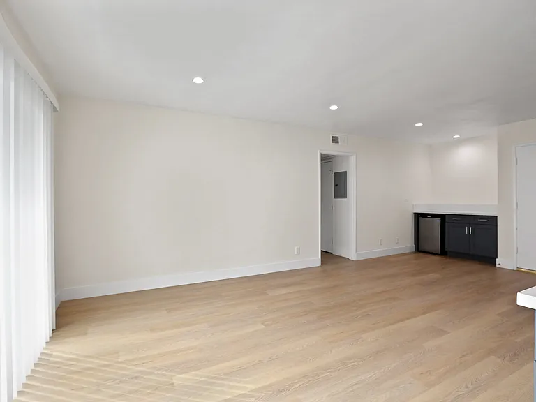 Open-Concept Living and Dining Room Areas with Recess Lighting and Vinyl Flooring