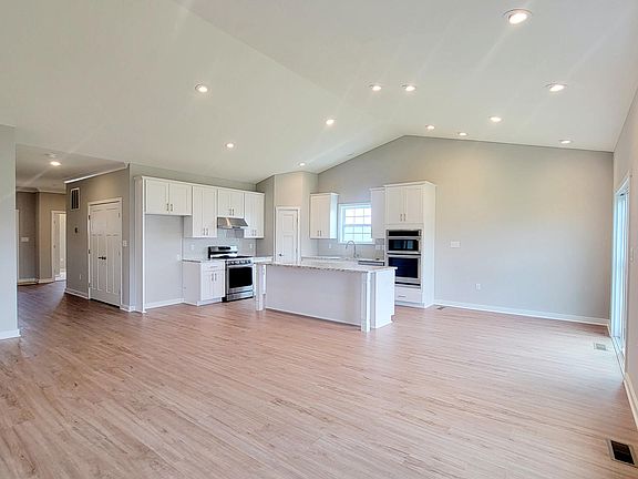 open kitchen family room with cathedral ceiling
