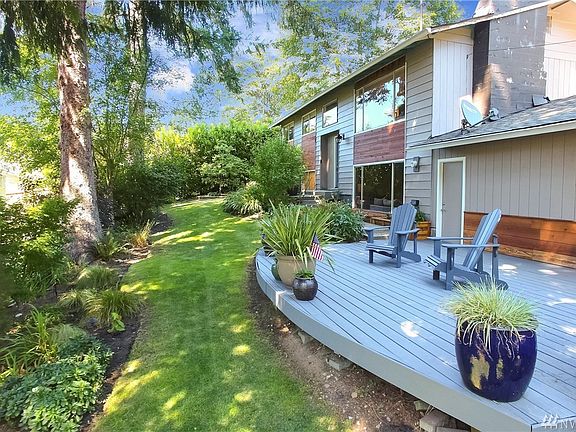 Front Door view with custom cedar planter boxes along house. Spacious Patio to enjoy sunsets. 