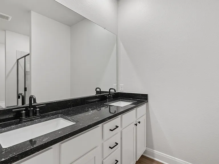 A dual sink vanity in the master bathroom.