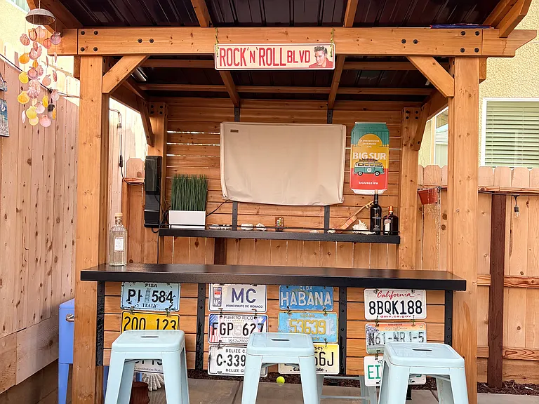 The patio includes a patio bar and TV, included with the rental