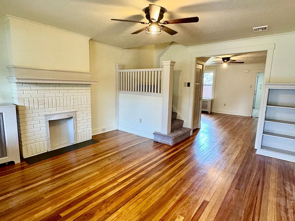 Living room looking into dining room - nice built ins and fireplace focal point.