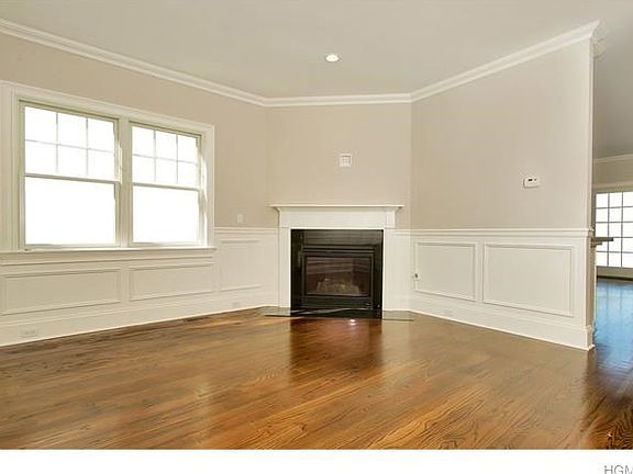 LIVING ROOM WITH CUSTOM MILL WORK & A GAS FIREPLACE.