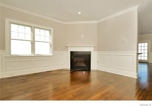 LIVING ROOM WITH CUSTOM MILL WORK & A GAS FIREPLACE.