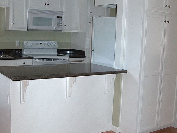 Brand new kitchen with custom cabinets and granite slab countertops