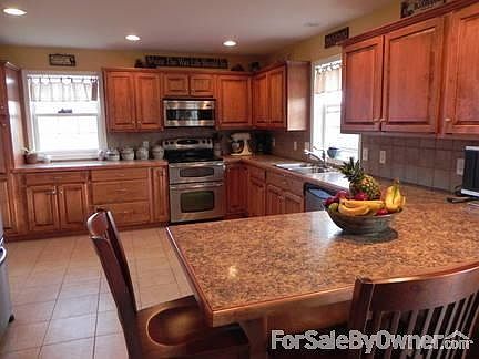 Large Kitchen
						:
						Custom cabinets, lots of recessed lighting, peninsula