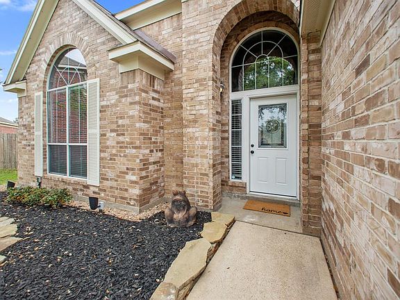 Here's a closer shot of the fresh landscaping, outdoor lighting and new front door.