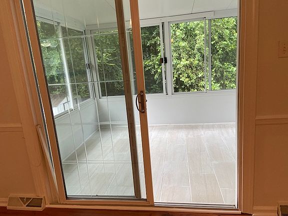 Sunroom with tiled floor, accesses from dining room