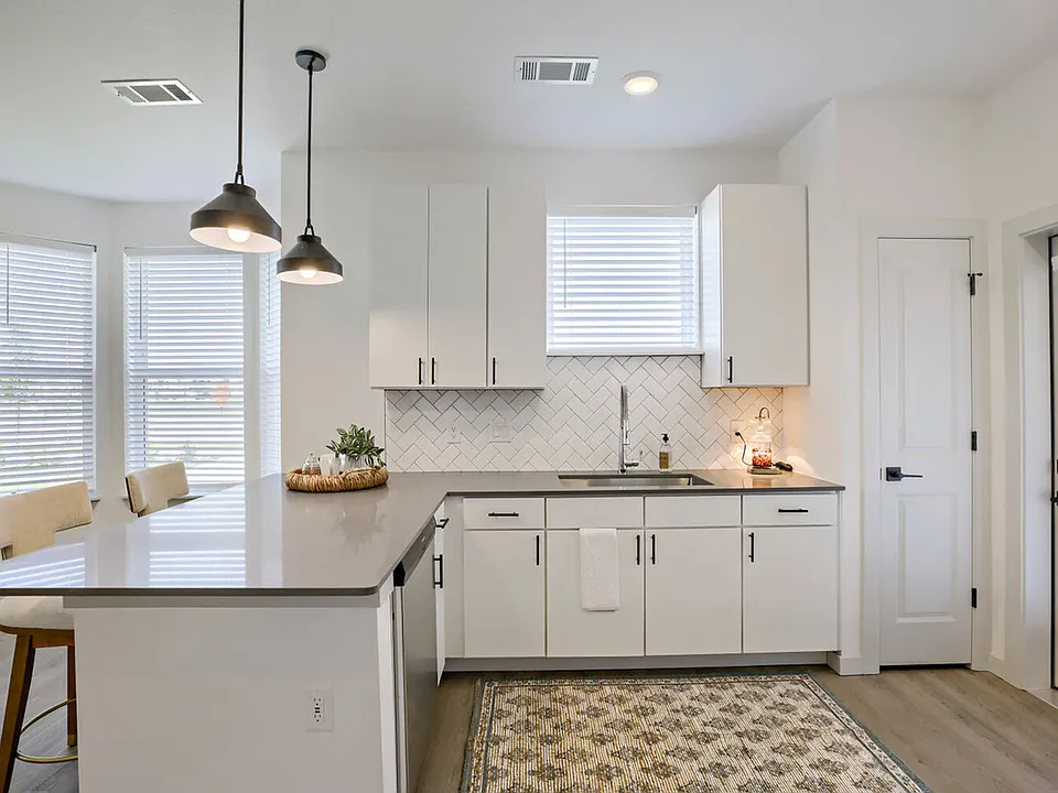 The wraparound peninsula with a dishwasher, and undermount sink gives you prep space, storage, and a view _ all at once. Garrett Harvest Junction West, Longmont, CO.