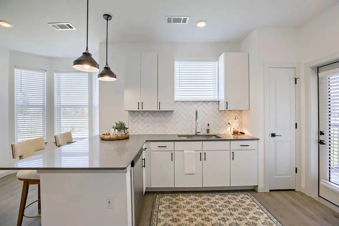 The wraparound peninsula with a dishwasher, and undermount sink gives you prep space, storage, and a view _ all at once. Garrett Harvest Junction West, Longmont, CO.