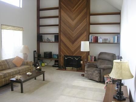 Livingroom offers vaulted ceiling & fireplace