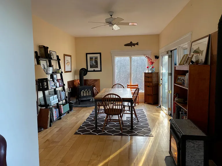 The dining room is also open to the living room, with a wood-burning stove and a propane stove