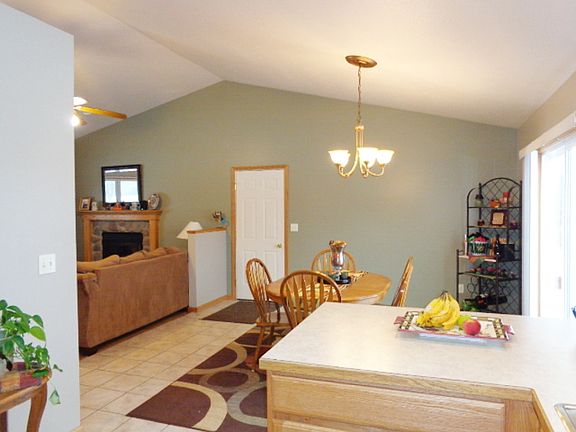 Dining area and kitchen have ceramic tile flooring and a sliding glass door to the deck and hot tub room. 