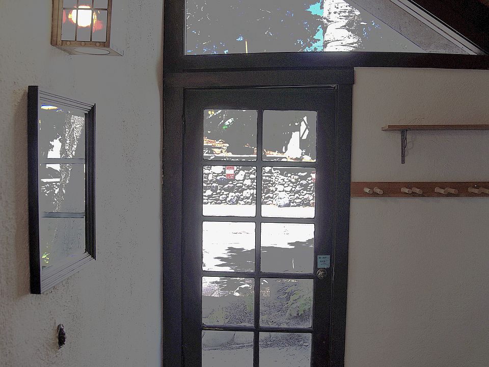Covered mud-room entrance for sports gear and firewood.