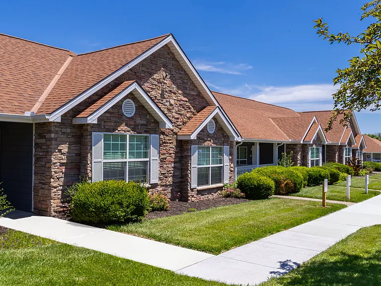 Experience the charm of Lenox West with our beautifully designed, stone-accented homes, surrounded by lush greenery and well-maintained pathways.