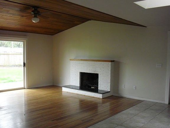 ~Living area w/hardwood floors and fireplace.
