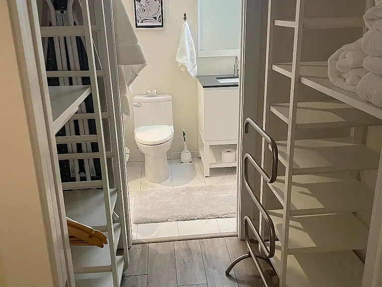 Walk-through closet with generous Ikea wardrobe units. Convenient pocket doors are featured throughout living area.