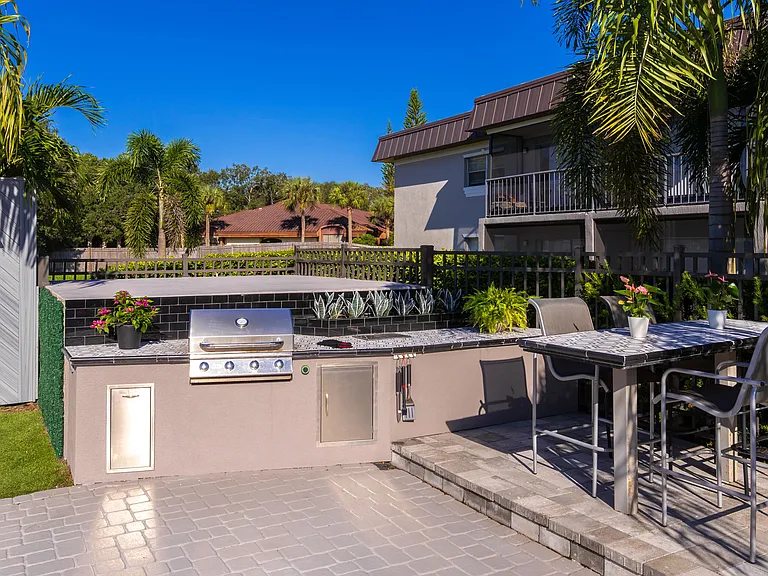 Host gatherings and enjoy alfresco dining at the outdoor kitchen featured on our expansive sundeck. Equipped with a built-in BBQ grill and modern seating, this space is perfect for cooking and socializing in a beautifully landscaped setting.