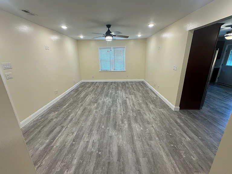 Living room: Bright living room with LVP flooring and ceiling fan