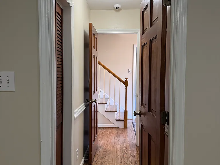 View down hallway from Bedroom #1 to foyer. Closet on left, full bath on right.