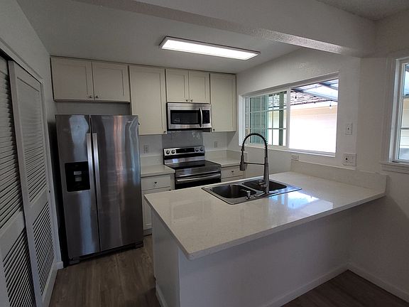 Immaculate kitchen, s/s appliances and a pass-through window outside to covered patio...large pantry closet and lots of linen/storage closets in the home.