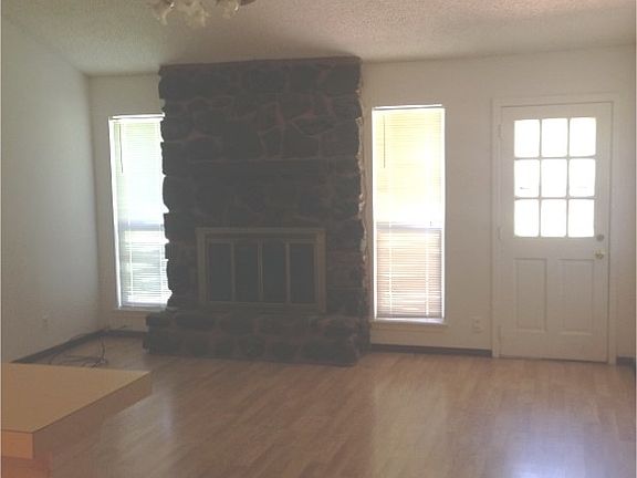 living room showing cathedral ceiling, fireplace and exterio
