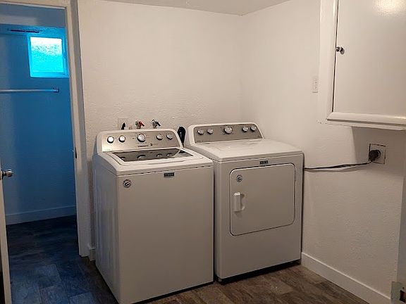 The laundry includes a very large drum washer and dryer.