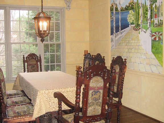 Formal dining room with faux stone work and custom mural