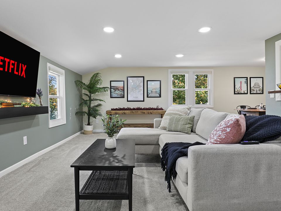 Open concept living with the living room, dining and kitchen area. The living room has a comfy couch, 58" smart TV, and corner swivel chair that''s perfect for morning coffee and sight seeing the neighborhood.