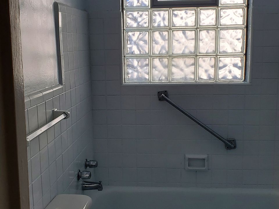 All white bathroom with a linen closet.